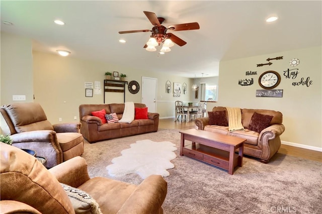 living area with a ceiling fan, recessed lighting, baseboards, and wood finished floors