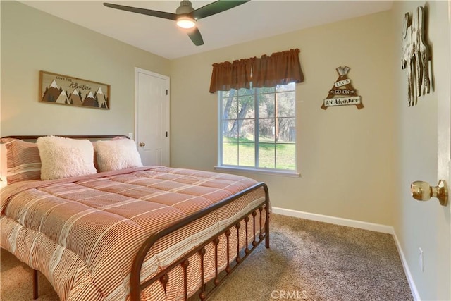 carpeted bedroom with ceiling fan and baseboards