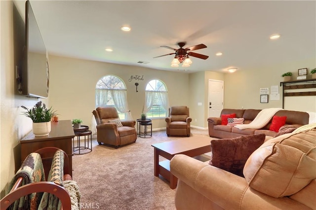 living area with recessed lighting, visible vents, baseboards, and light colored carpet