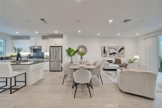 dining room with light wood-style floors, visible vents, and recessed lighting