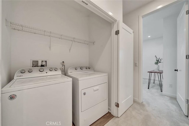 laundry area with baseboards, laundry area, washing machine and clothes dryer, and light colored carpet