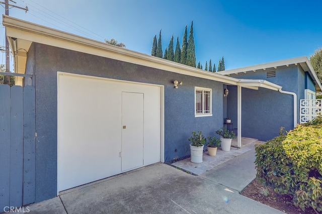 entrance to property featuring a patio and stucco siding