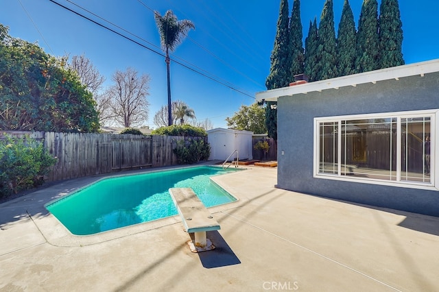 view of pool with a fenced backyard, a storage shed, an outdoor structure, a fenced in pool, and a patio area