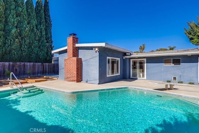 view of swimming pool with a fenced in pool, a patio area, and fence