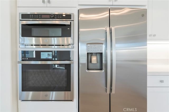 kitchen with appliances with stainless steel finishes and white cabinetry