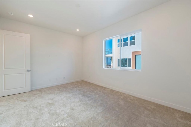 unfurnished room featuring carpet floors, recessed lighting, and baseboards