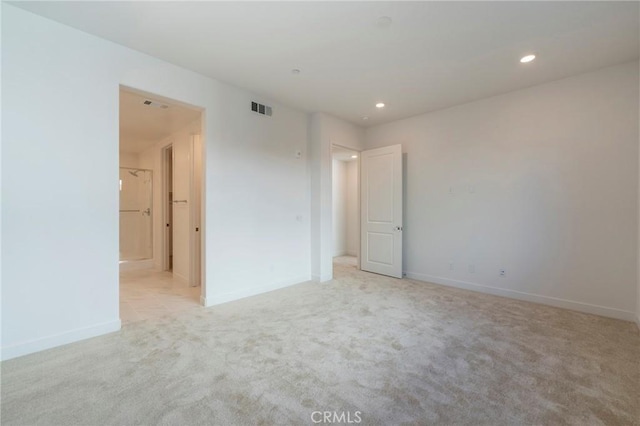 unfurnished bedroom with light colored carpet, visible vents, baseboards, and recessed lighting