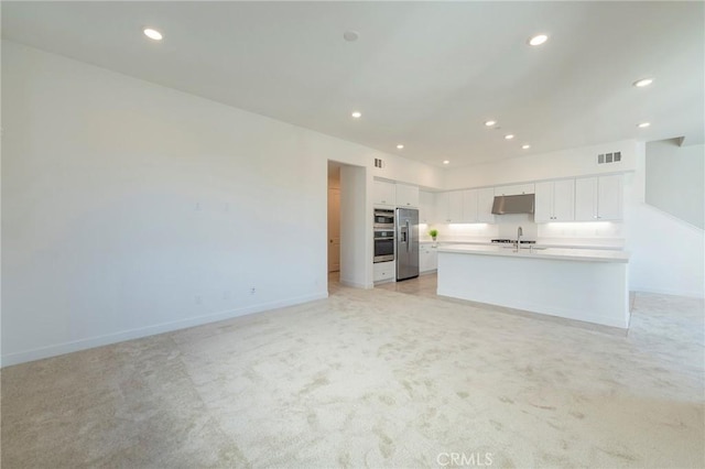 unfurnished living room with light colored carpet, recessed lighting, a sink, visible vents, and baseboards