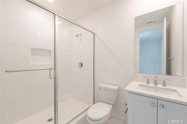 full bathroom featuring a stall shower, visible vents, vanity, and toilet