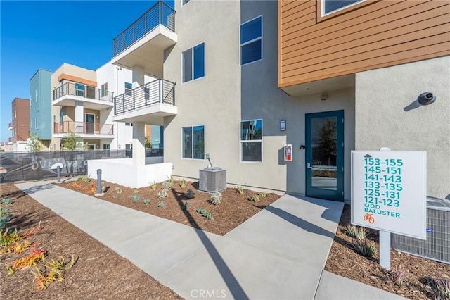 exterior space with central air condition unit and stucco siding