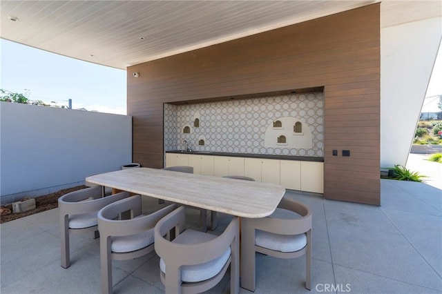 view of patio featuring outdoor dining area