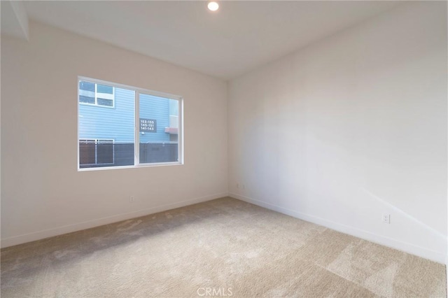 unfurnished room with recessed lighting, light colored carpet, and baseboards