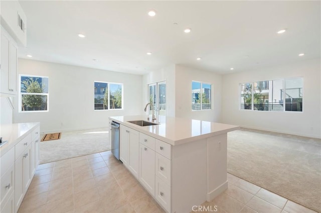 kitchen with recessed lighting, light carpet, a sink, open floor plan, and dishwasher