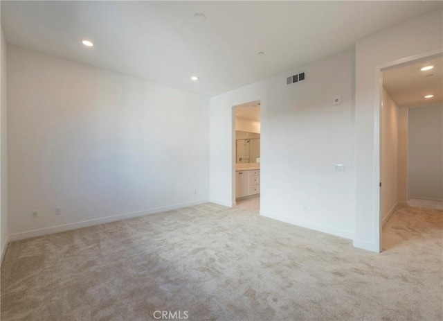 unfurnished bedroom with light carpet, baseboards, visible vents, and recessed lighting