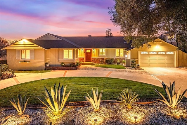 single story home with a yard, driveway, and a garage