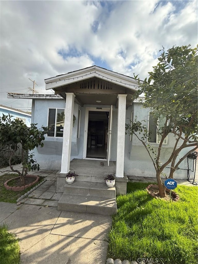 property entrance with stucco siding