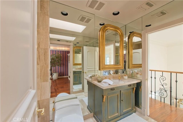 bathroom with vanity and visible vents