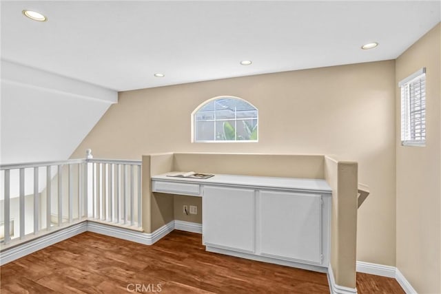 bonus room with recessed lighting, baseboards, built in desk, and wood finished floors