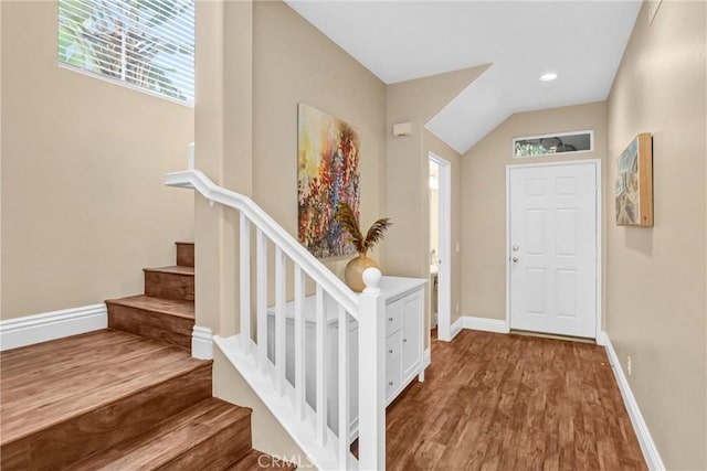 foyer featuring recessed lighting, wood finished floors, baseboards, and stairs