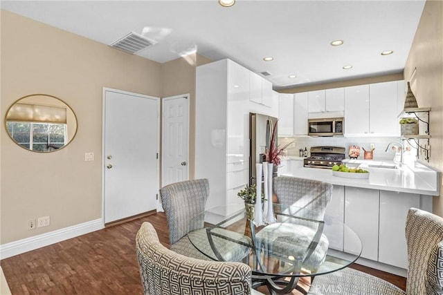 dining area with recessed lighting, wood finished floors, visible vents, and baseboards