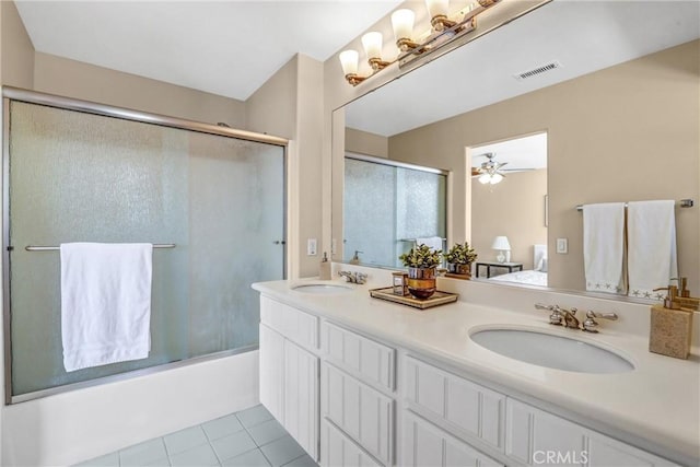 bathroom featuring bath / shower combo with glass door, ensuite bath, a sink, and visible vents