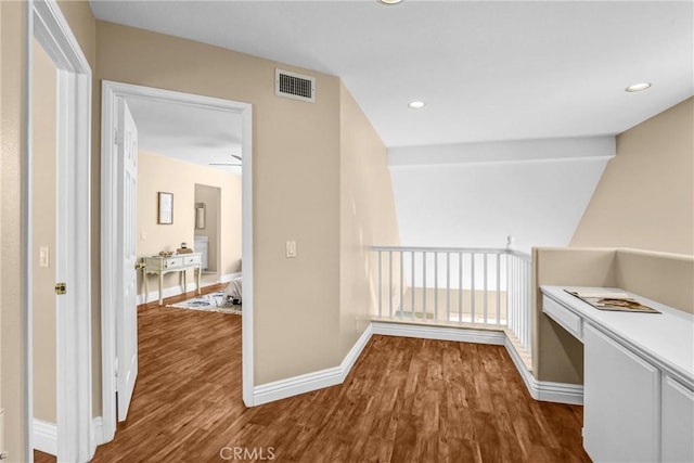 hall with baseboards, visible vents, wood finished floors, and recessed lighting