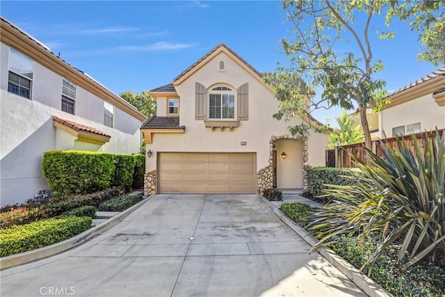 mediterranean / spanish-style house featuring an attached garage, fence, driveway, a tiled roof, and stucco siding