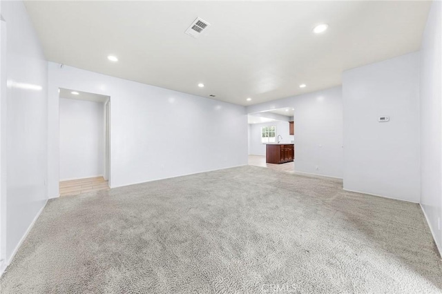 empty room with visible vents, light colored carpet, and recessed lighting