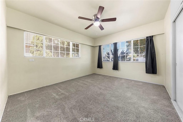 spare room featuring carpet floors and ceiling fan