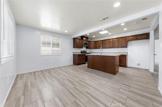 kitchen featuring light countertops, appliances with stainless steel finishes, visible vents, and recessed lighting