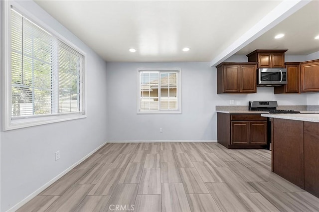 kitchen featuring appliances with stainless steel finishes, recessed lighting, light countertops, and baseboards