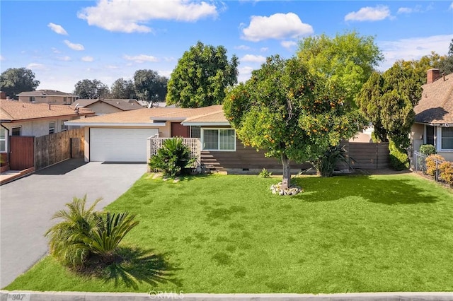 ranch-style house with driveway, crawl space, an attached garage, fence, and a front lawn