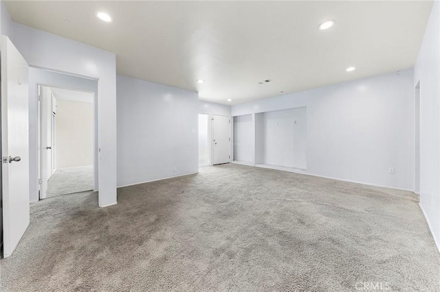 empty room with recessed lighting and carpet flooring