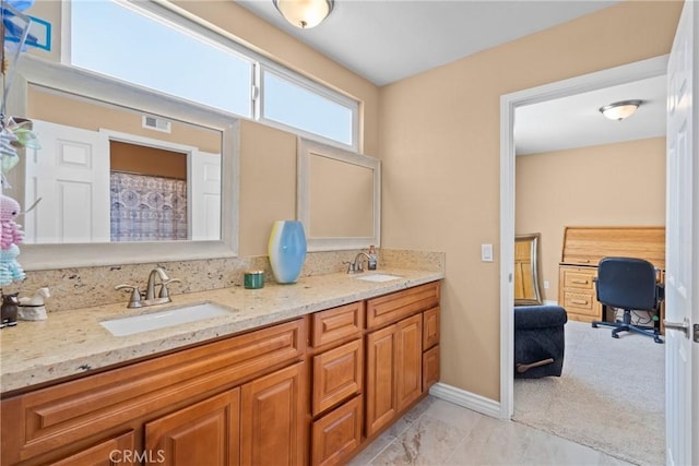 full bathroom featuring double vanity, visible vents, baseboards, and a sink