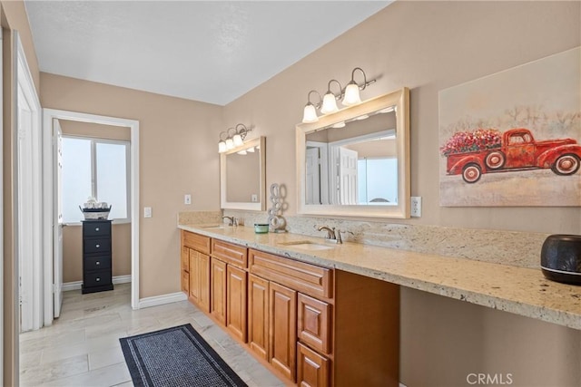 full bathroom featuring a sink, a wealth of natural light, and double vanity