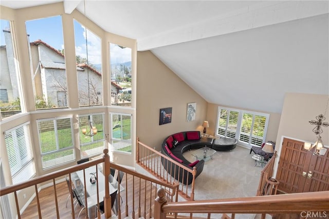 living area featuring beamed ceiling and high vaulted ceiling