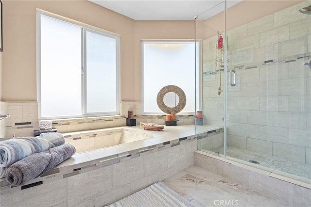 bathroom with a bath and a shower stall