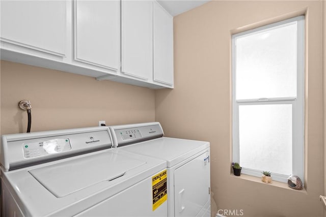 laundry area with cabinet space and independent washer and dryer