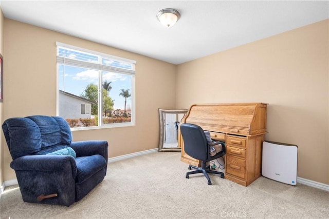 home office with baseboards and light carpet