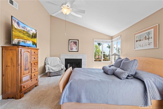 bedroom with lofted ceiling, carpet, visible vents, a fireplace, and a ceiling fan
