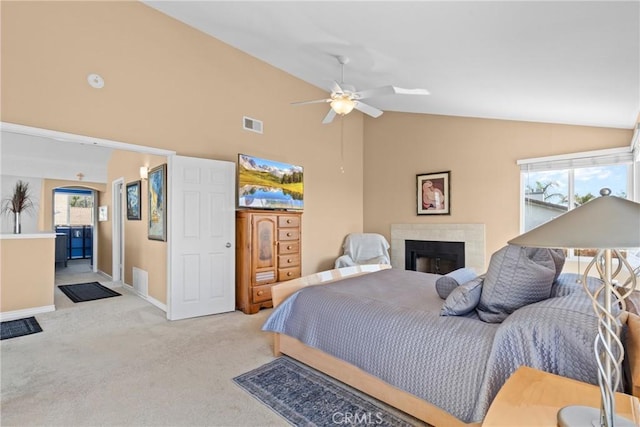 bedroom featuring baseboards, ceiling fan, light colored carpet, lofted ceiling, and a fireplace