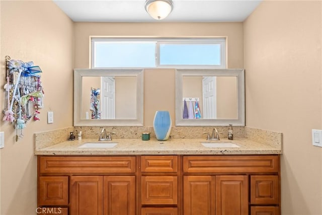 full bath with a sink and double vanity