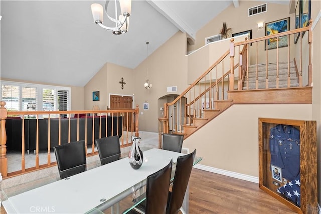 dining area with visible vents, stairway, beam ceiling, an inviting chandelier, and wood finished floors