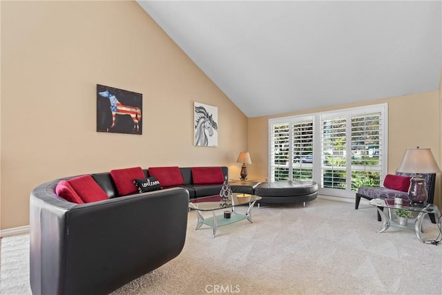 carpeted living room featuring lofted ceiling and baseboards