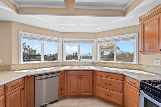 kitchen featuring a sink, brown cabinets, appliances with stainless steel finishes, and ornamental molding