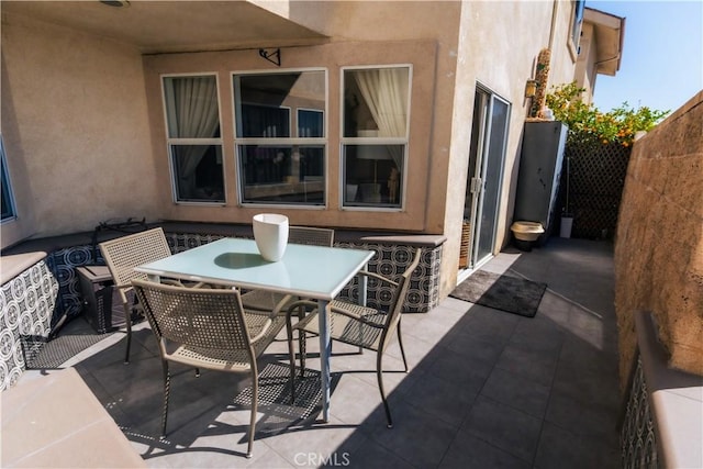 view of patio featuring outdoor dining space and fence