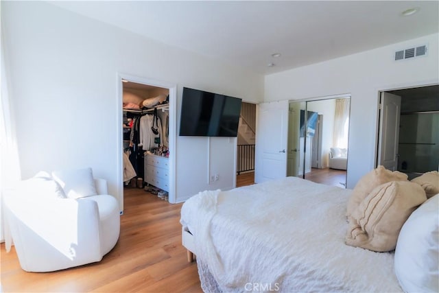 bedroom featuring visible vents and light wood-style floors