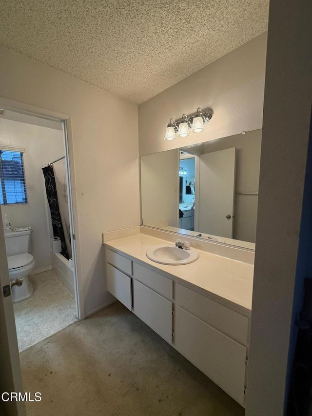 bathroom featuring a textured ceiling, toilet, shower / tub combo, vanity, and washer / clothes dryer