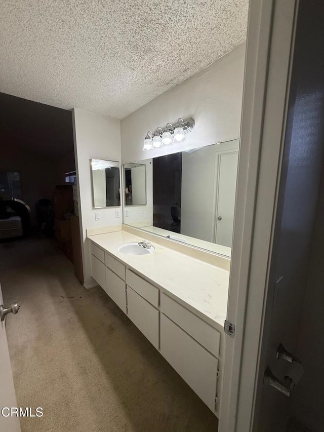 bathroom featuring a textured ceiling and vanity