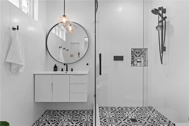 bathroom featuring a shower stall and vanity